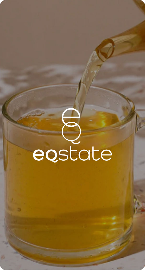 hot herbal tea being poured into glass cup, warm natural wellness drink close up