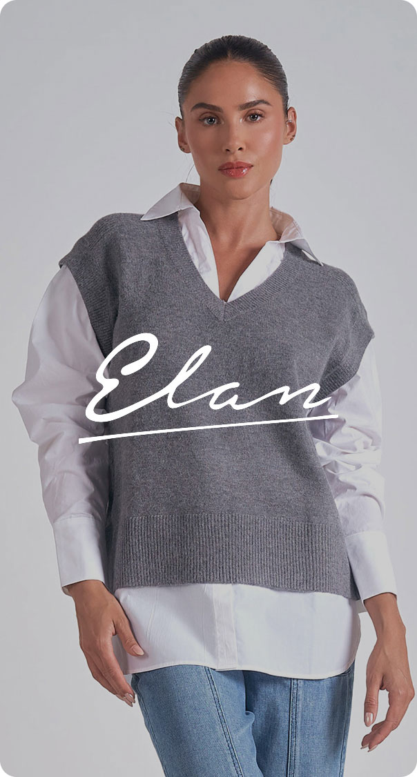 woman wearing layered outfit with white shirt and gray vest, minimalist fashion style