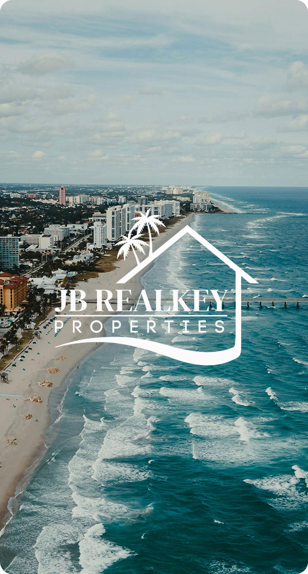 aerial view of coastline with beachfront buildings and ocean waves in florida