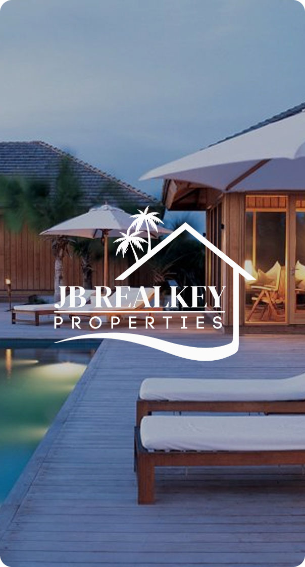 modern luxury villa with poolside lounge chairs and outdoor seating area at sunset