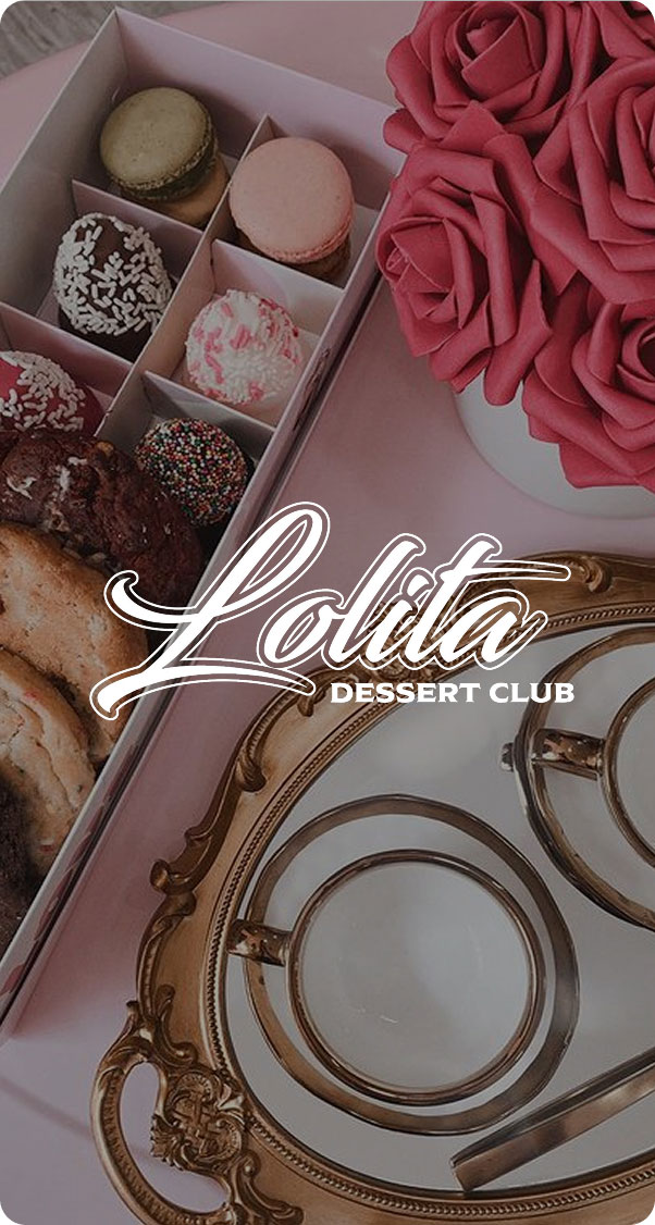 luxury dessert box with macarons chocolates and assorted sweets next to pink roses and elegant table setting, gourmet dessert gift concept