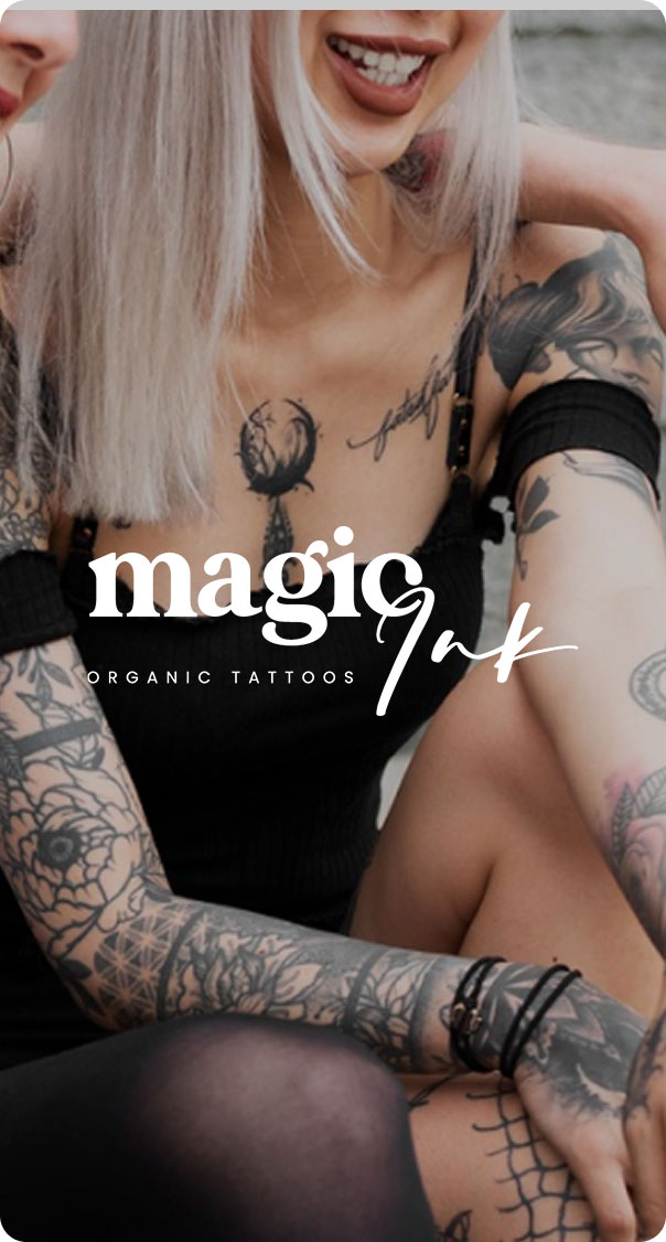 woman with multiple minimalist black ink tattoos on arms and chest smiling