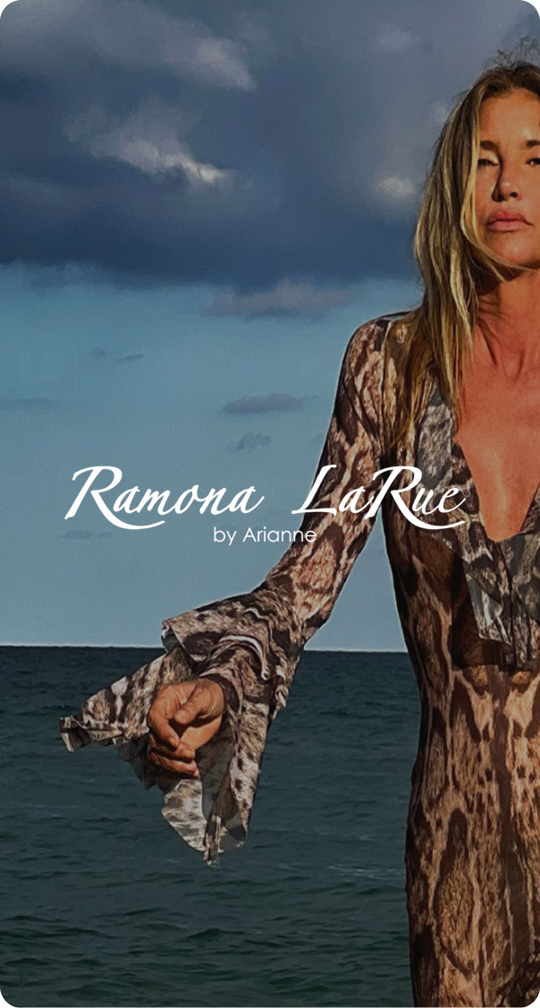 woman wearing elegant patterned dress by the ocean under dramatic sky, luxury beachwear fashion concept