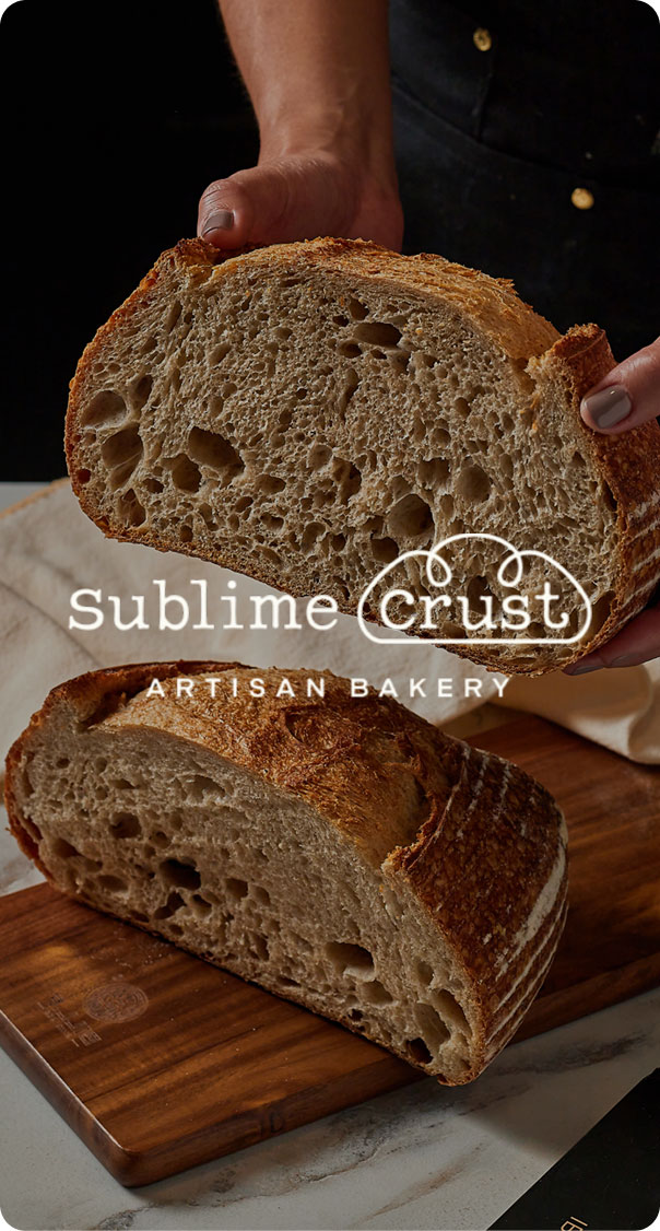 freshly baked artisan bread cut in half showing texture and crumb, featured in a bakery branding project by a miami web design agency
