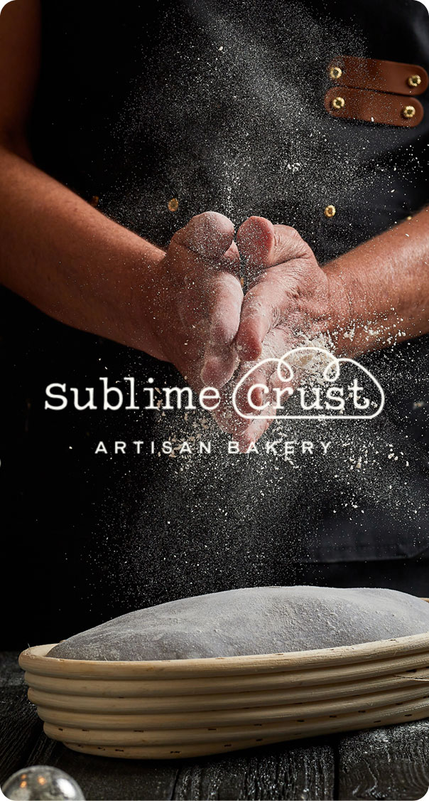 artisan baker hands tossing flour over dough preparation, featured in a bakery branding project by a miami web design company