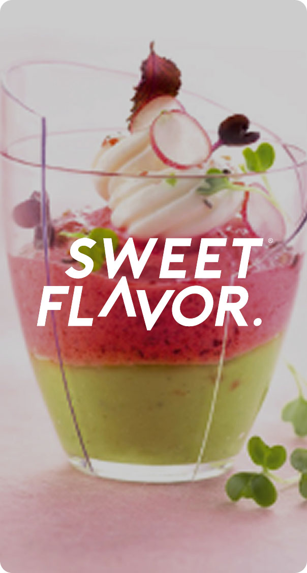 Alt Text: layered fruit dessert in a clear cup with cream topping and edible garnish, part of a food branding project by a web design miami company