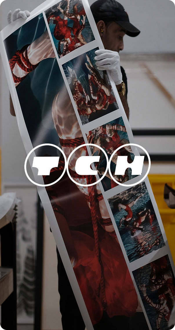 technician installing large format print panel with photo collage in studio