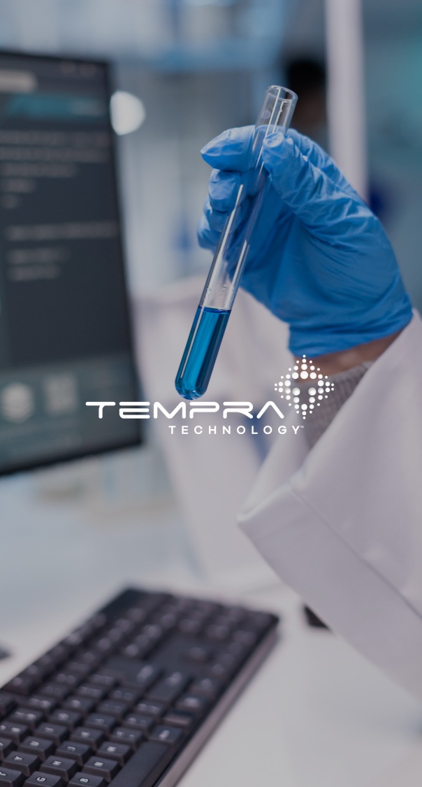 Scientist holding test tube with blue liquid in laboratory, representing Tempra Technology innovation and research