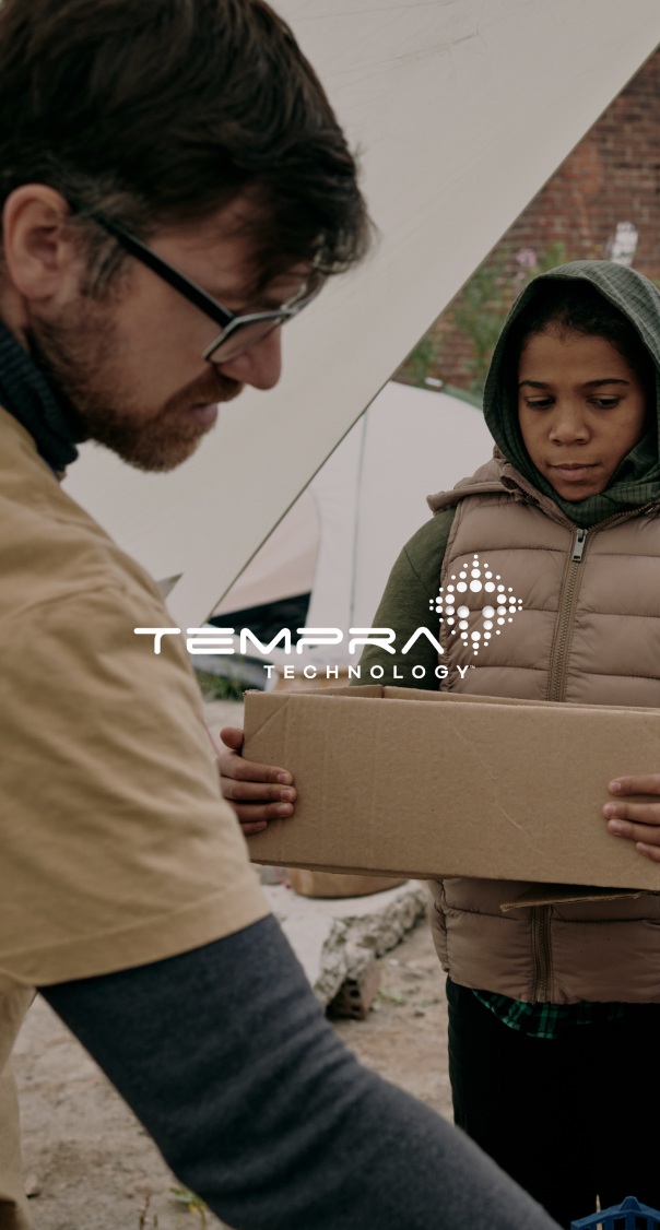 worker handing a package to another person in an outdoor setting, featured in a technology and logistics branding project by a miami web design company