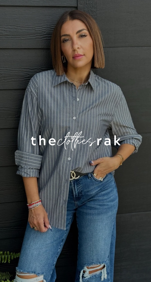 woman wearing casual striped shirt and ripped jeans leaning against wall, featured in a fashion branding project by a miami web design agency